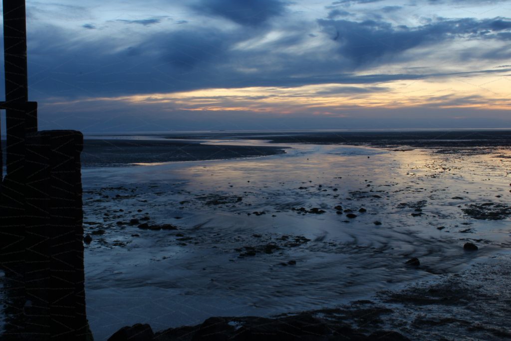 Water rushes into the sea in twilight
