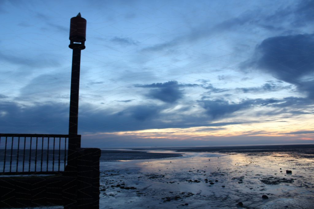 Water rushes into the sea in twilight